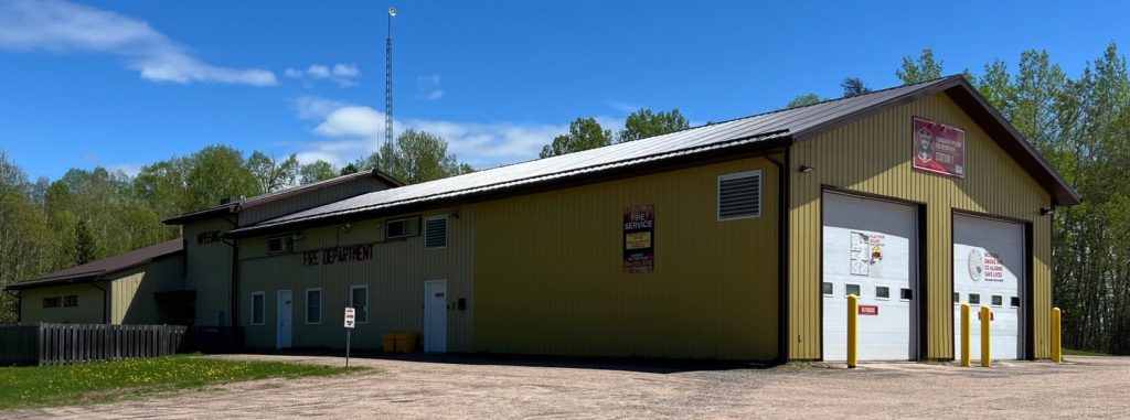 A view of the community centre from the outside. A large building with lots of space for gathering.