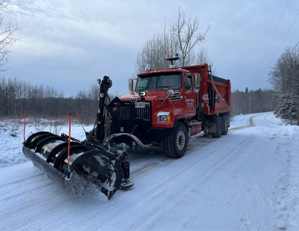 A snow plow doing winter road maintenance.