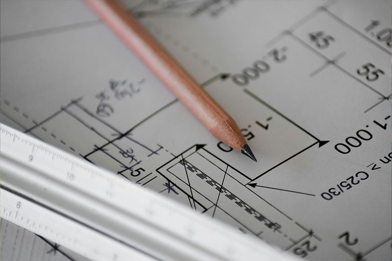 A pencil and ruler on a drawn building plan for the Committee of Adjustment to look at.